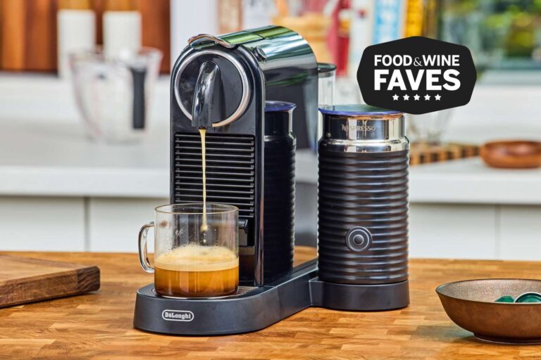 A modern silver Nespresso coffee machine prepared for making a fresh cup of coffee.